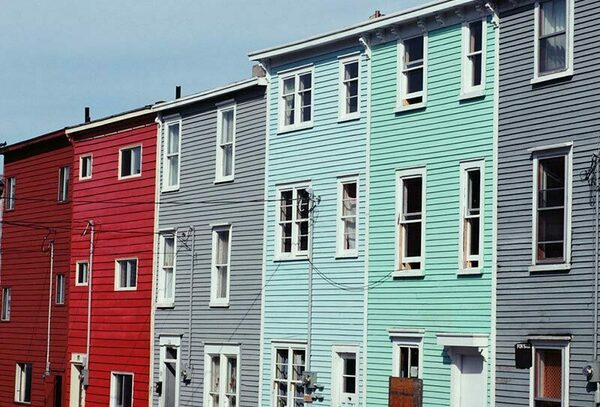 Colorful three story row homes seen at an angle
